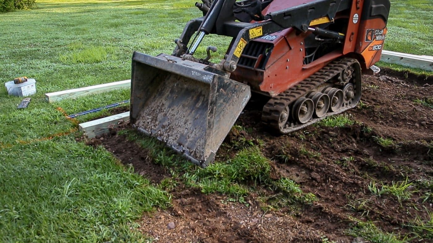 A shed foundation company in Ohio removing topsoil for a shed base