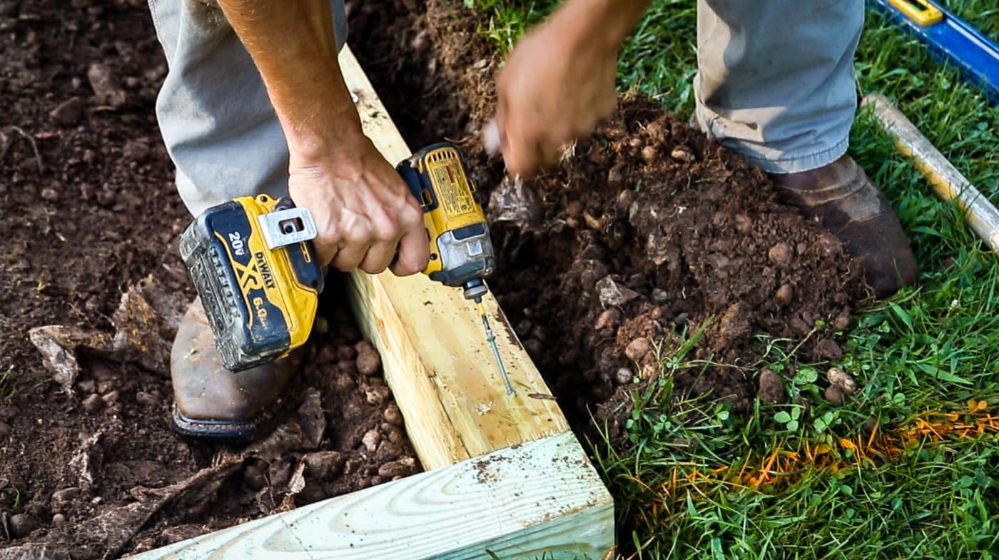 A shed foundation company in Ohio installing a shed base