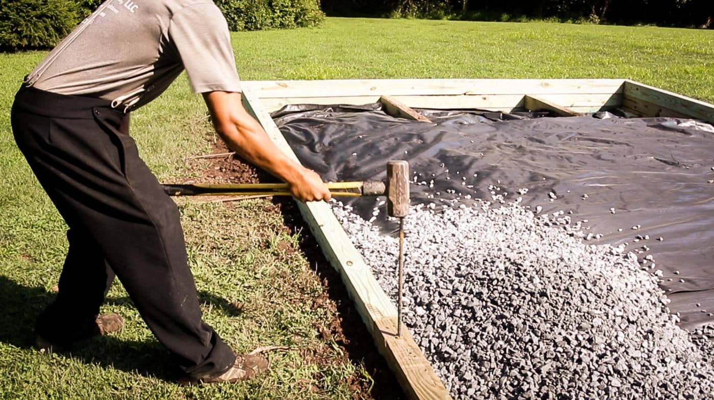 A shed foundation company in PA installing a shed base