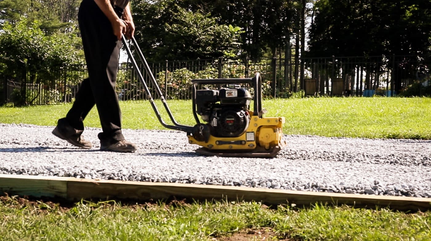 A shed foundation company in PA compacting crushed stone