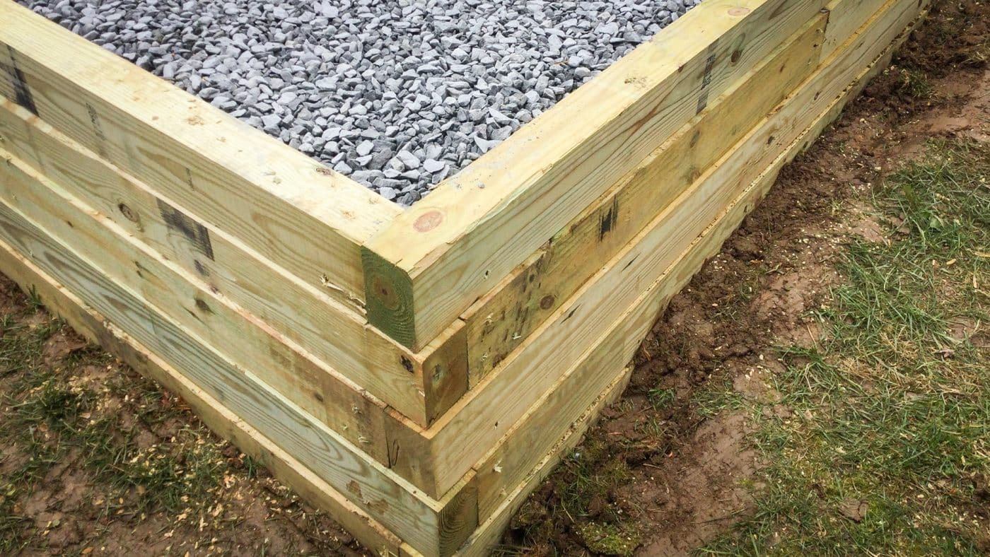 A built-up gravel hot tub pad on a slope