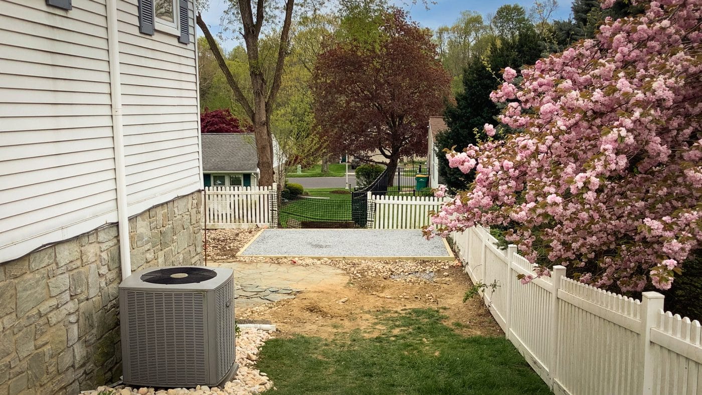 A gravel area for a fire pit in a backyard