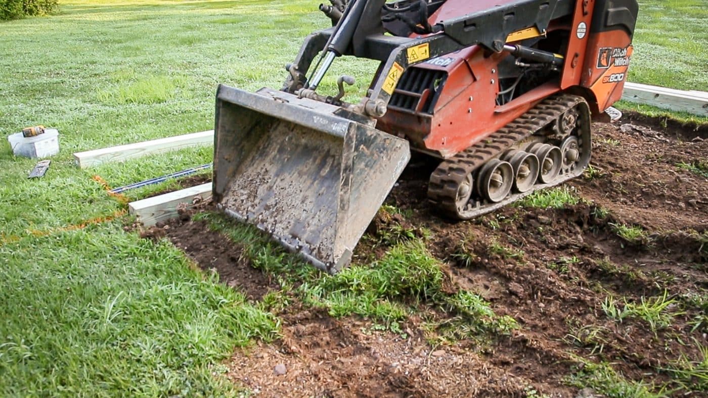 Removing topsoil for a gravel patio fire pit area