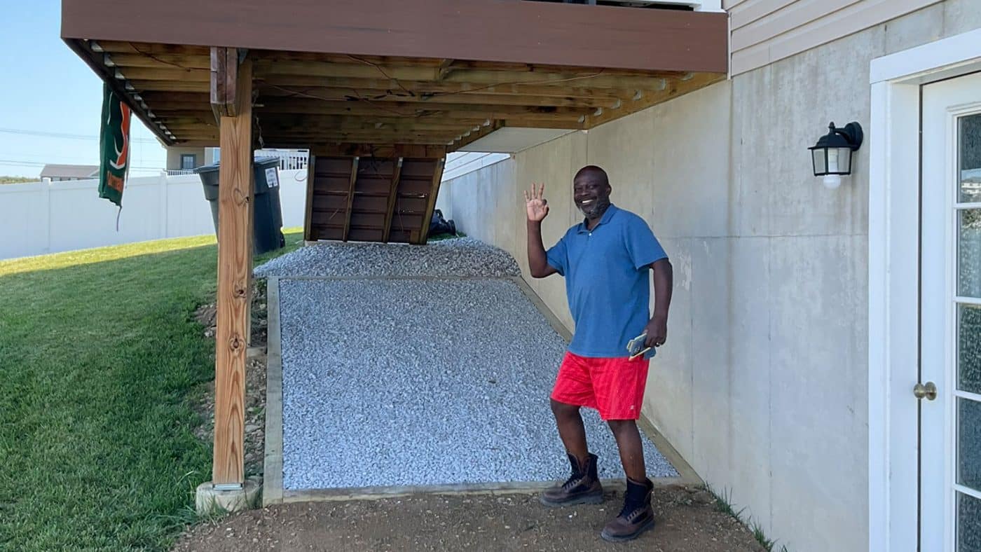 happy customer by deck with gravel under deck