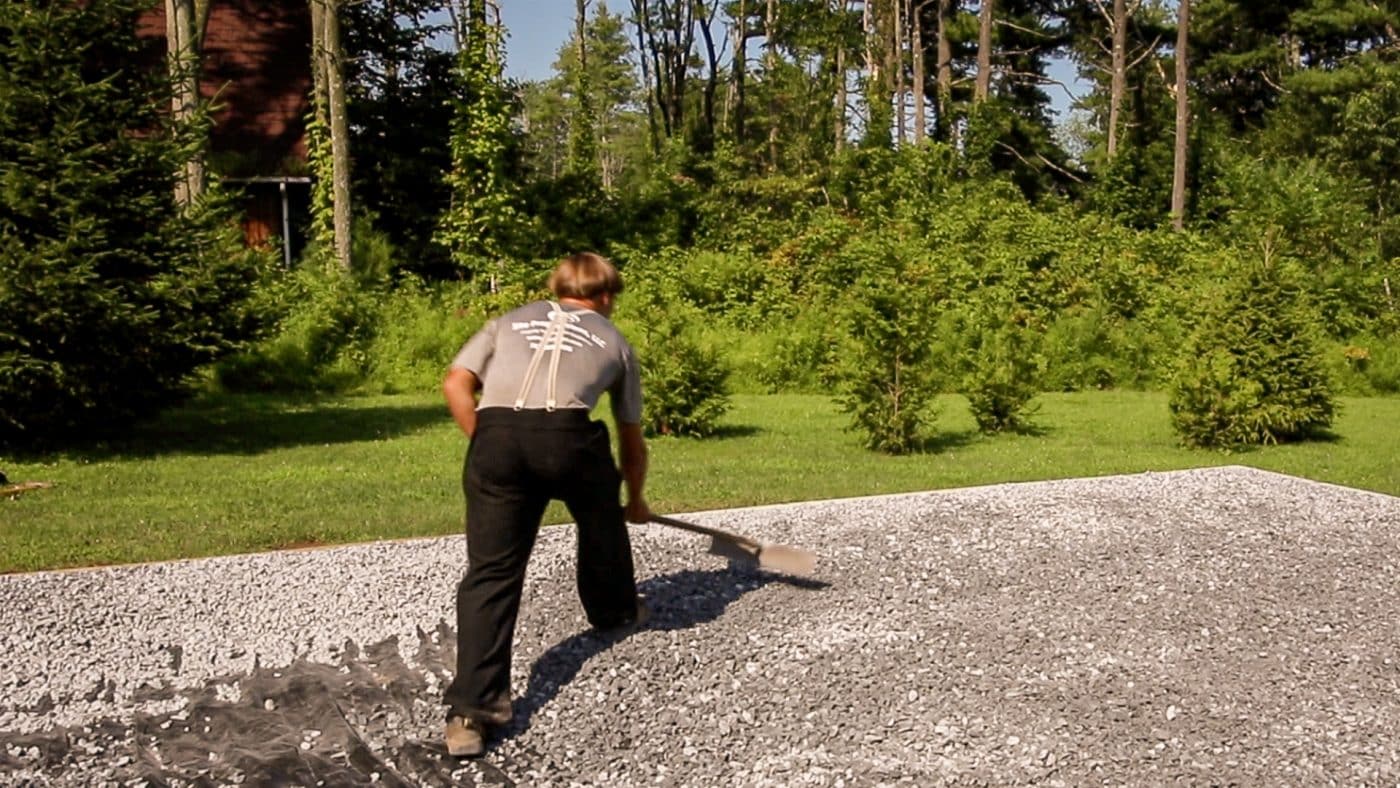 Spreading gravel under a deck