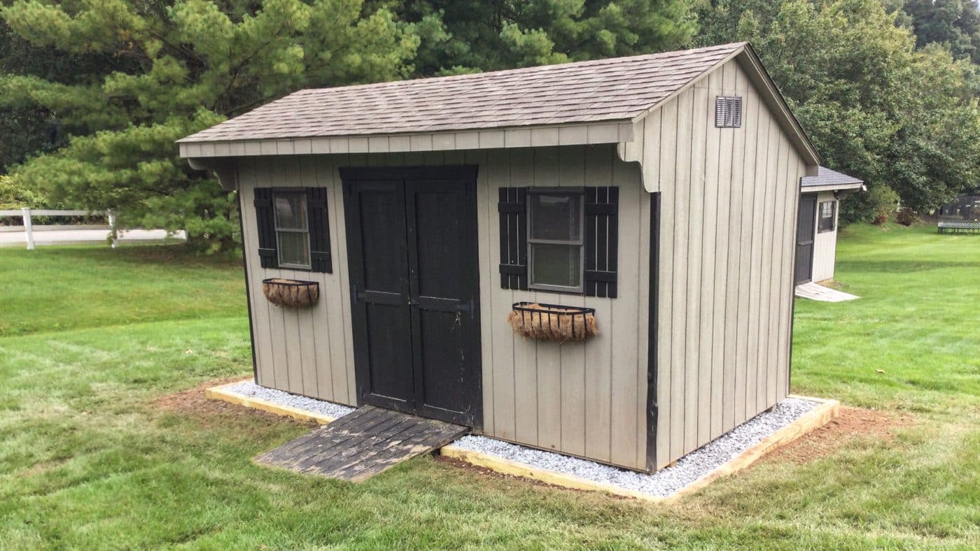 exterior of a shed on a gravel shed base for the article how to build a shed base on uneven ground