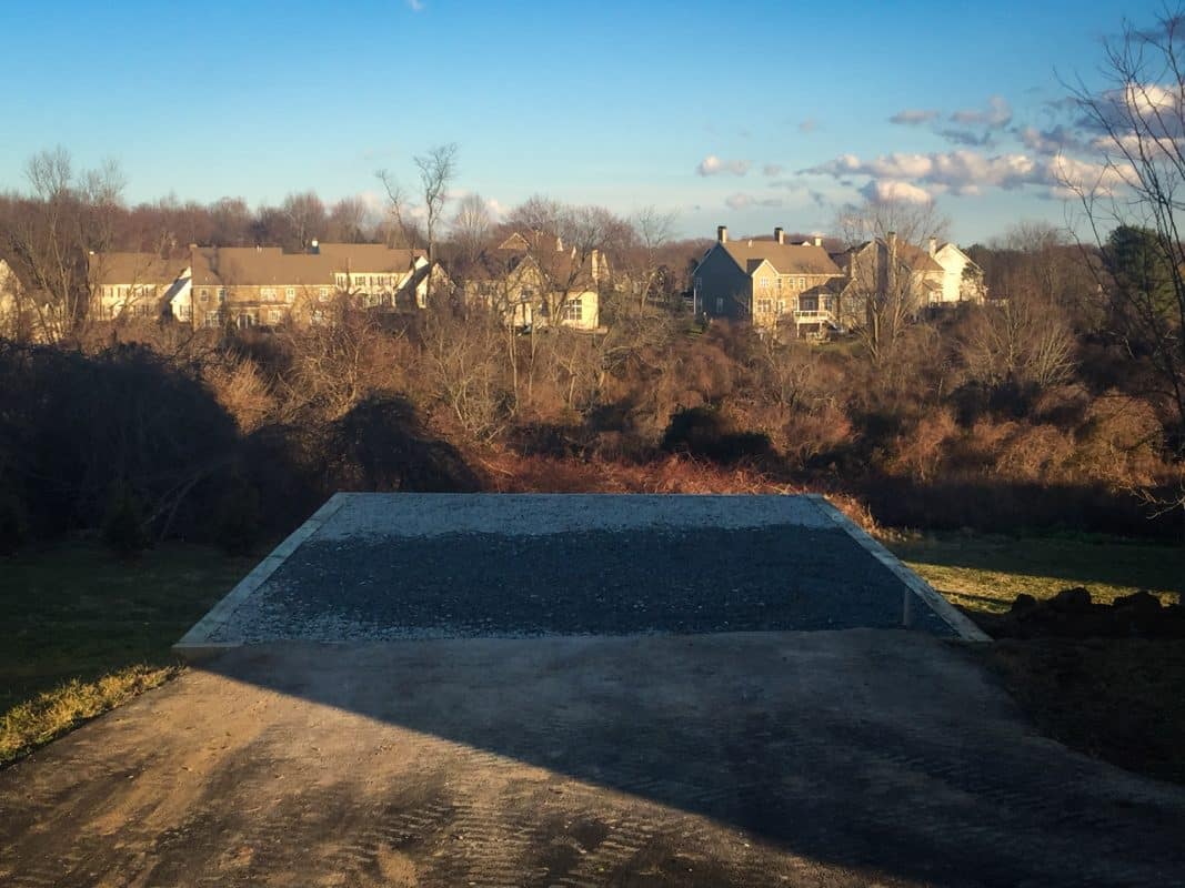 Gravel shed foundation in shadow