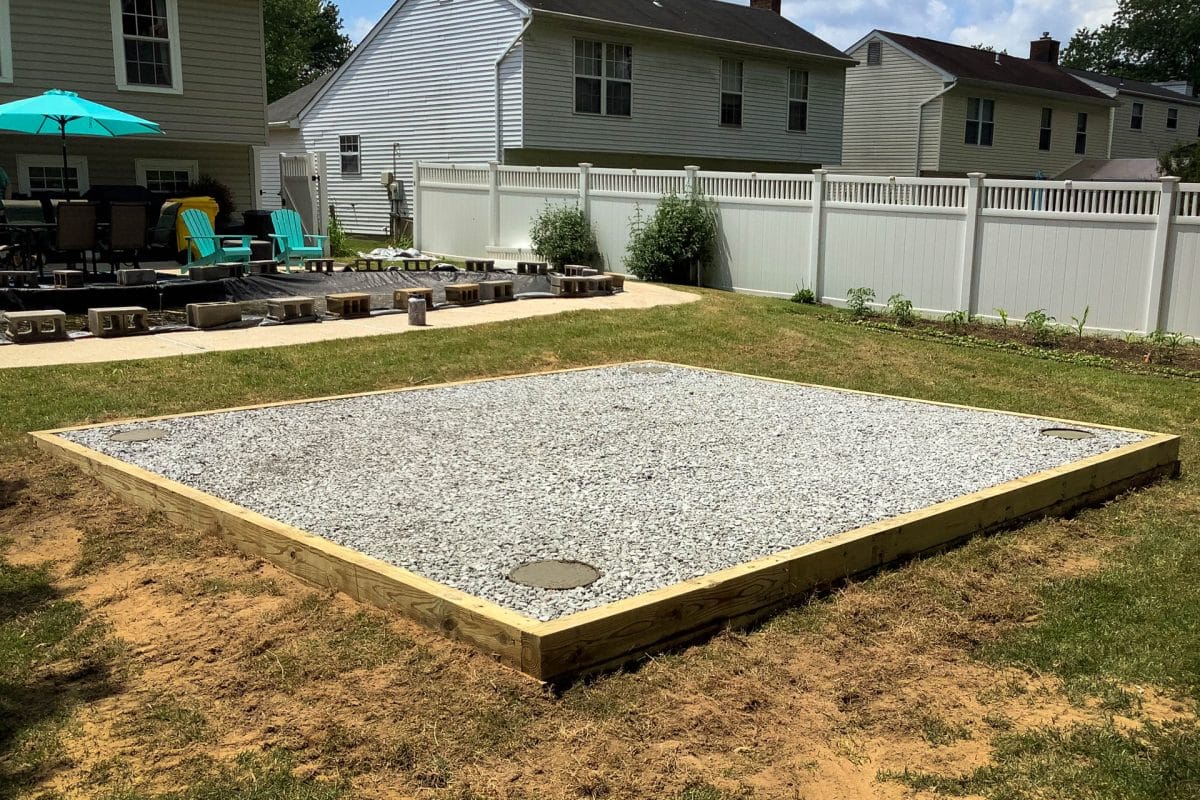 Concrete piers used to anchor a shed into gravel.