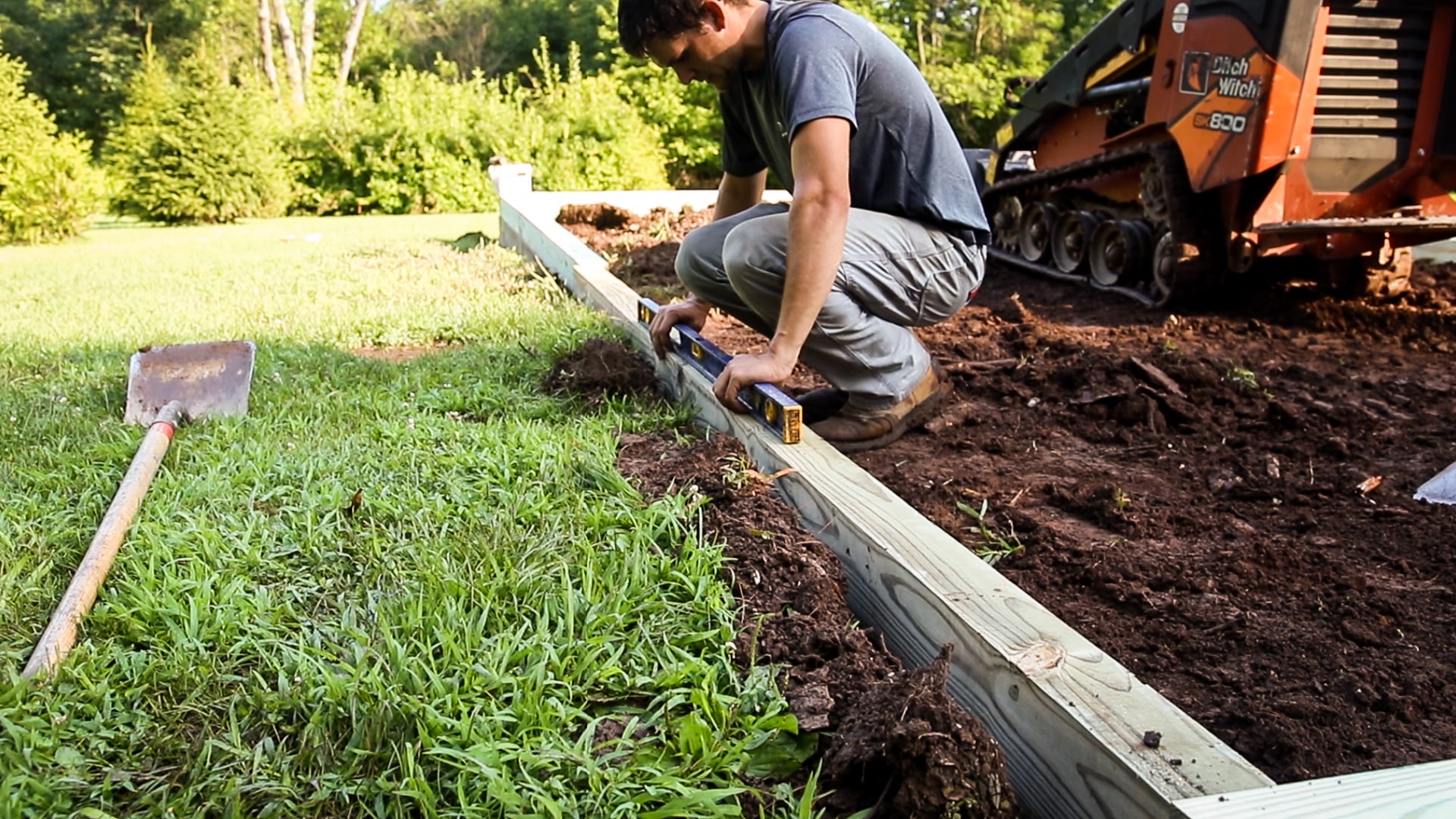 Demonstrating how to level the ground for a shed